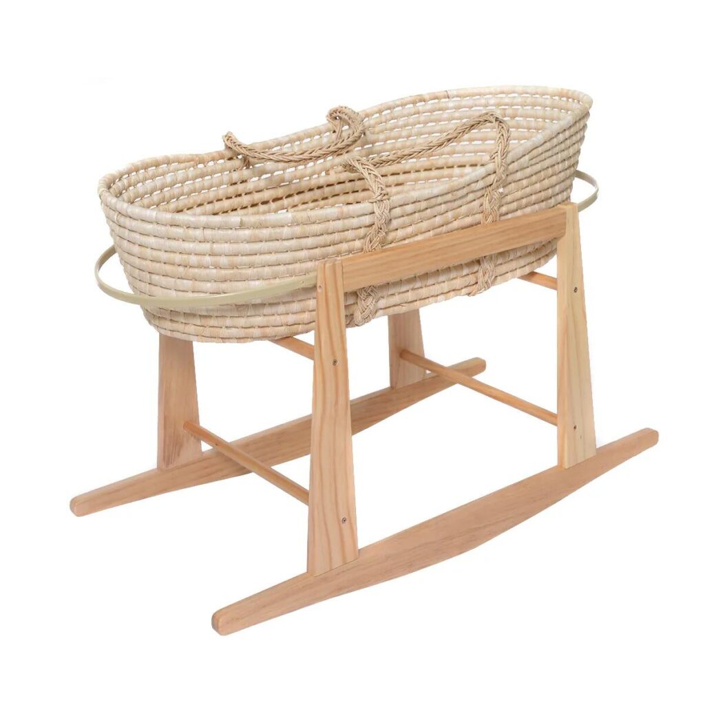 A stylish and modern Moses basket made from sustainable materials in a beautifully decorated nursery
