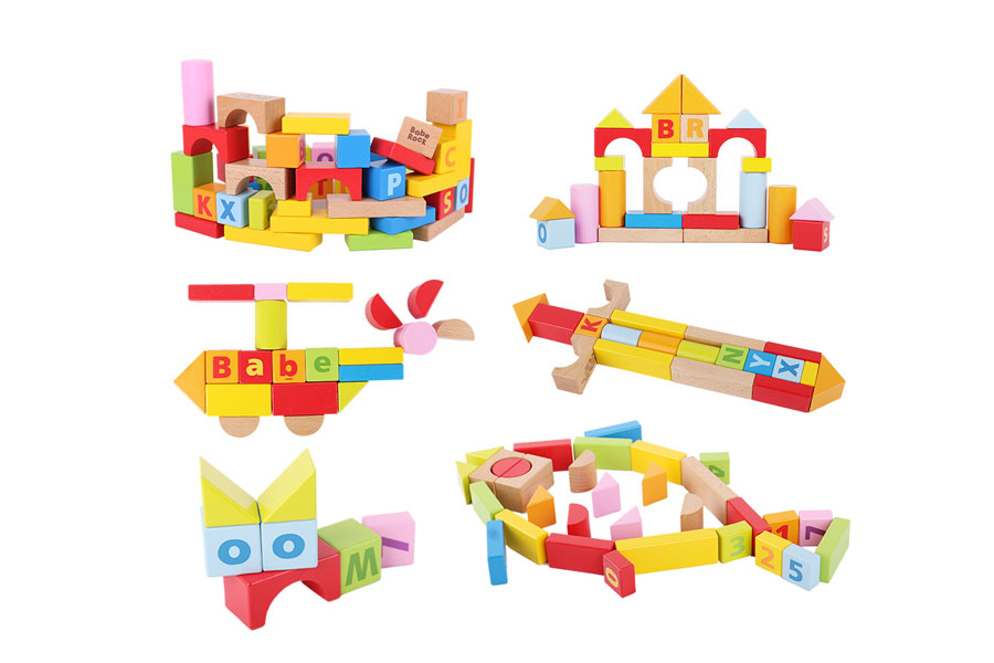 A child looking thoughtful while building a complex structure with simple wooden unit blocks.
