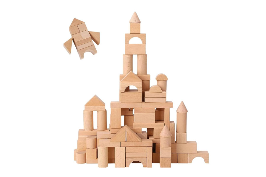 A vibrant rainbow stacker next to a natural wood stacking toy showing a contrast in styles