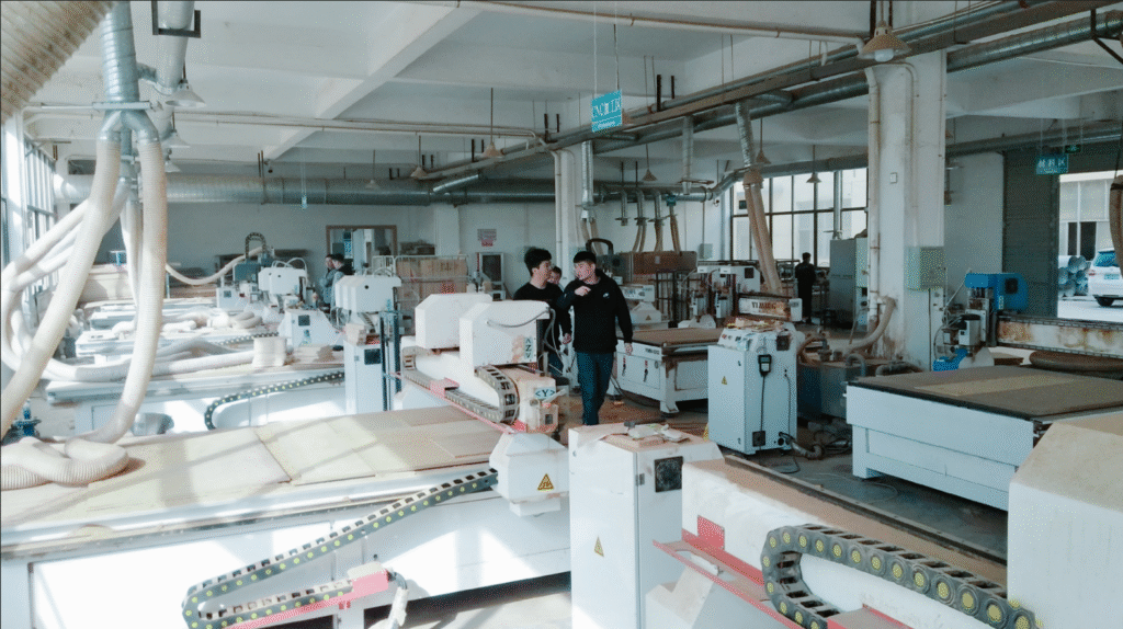A CNC machine precisely cutting the frame of a wooden balance bike
