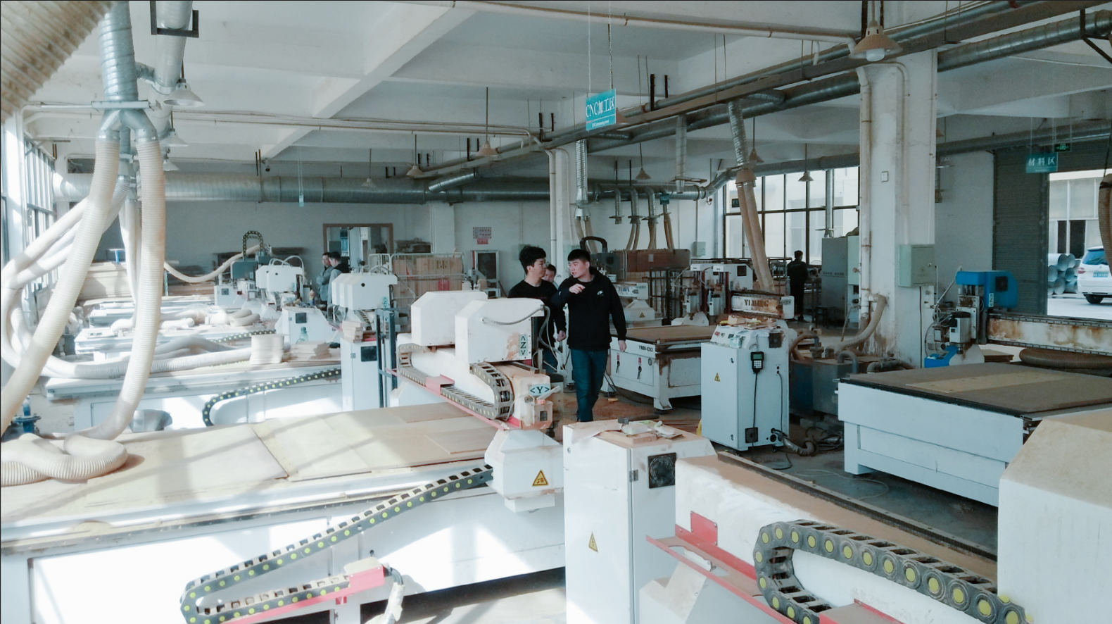 A CNC machine precisely cutting the frame of a wooden balance bike