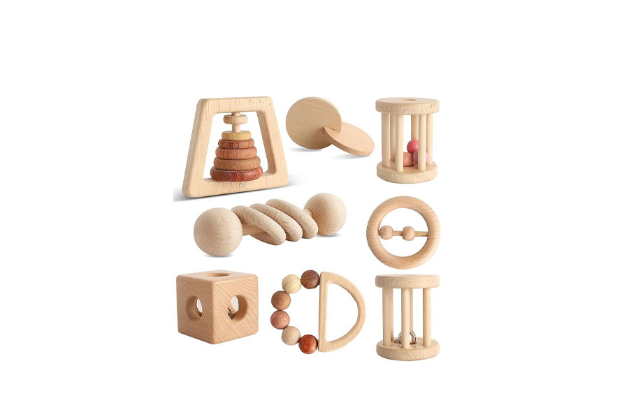 A display of Montessori materials including wooden blocks, metal bells, and fabric balls.