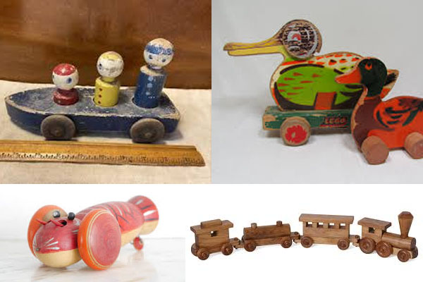A person closely inspecting an old painted wooden toy for chips and cracks
