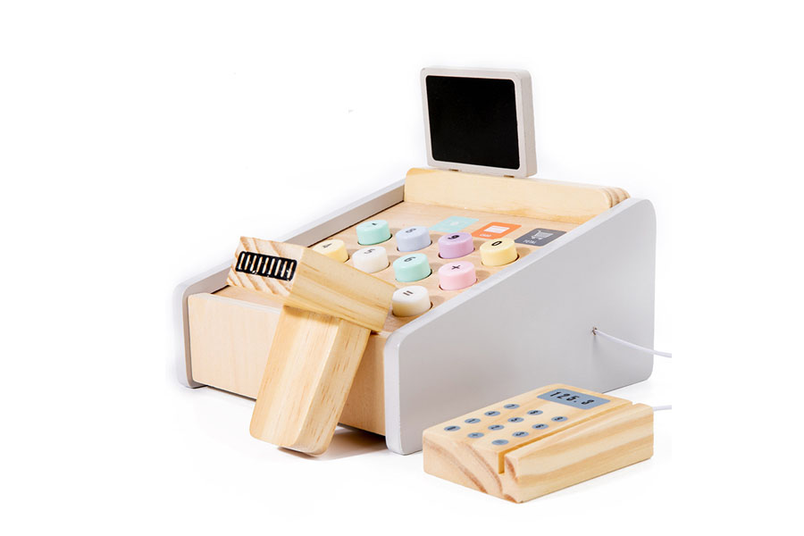 A close-up of colorful wooden play coins and paper money next to the cash register