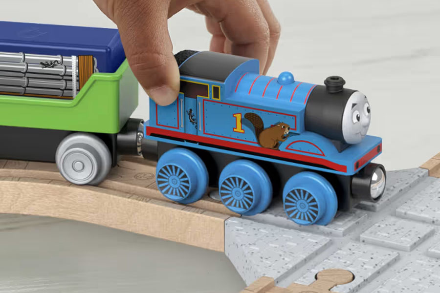 A collection of different Thomas & Friends wooden engines lined up, showing their distinct faces and colors.