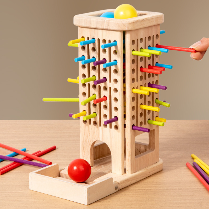 A one-year-old concentrating as they place a ring on a vertical stacker.