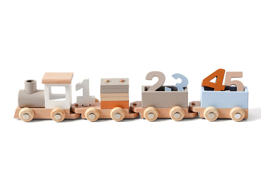 A simple, chunky wooden truck for toddlers next to a more complex fire truck for preschoolers.