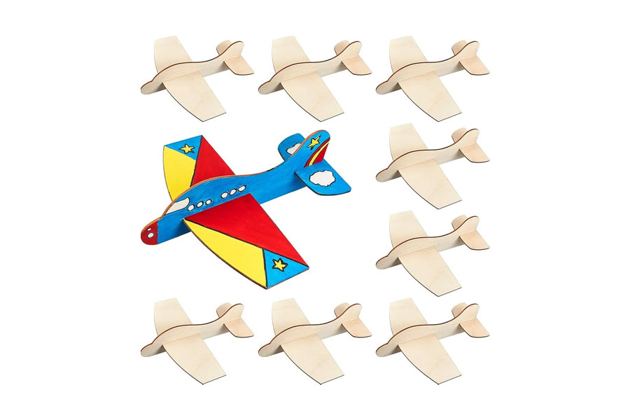 A simple wooden plane sitting on a rug, looking sturdy and ready for play
