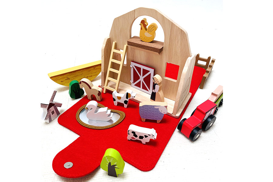 A toy barn with a matched set of wooden animals and fences included in the box