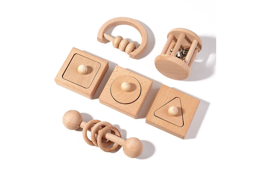 A variety of well-designed wooden infant toys showing simple, easy-to-hold shapes and sizes
