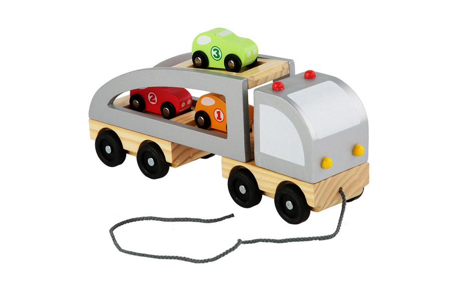 A wooden toy truck with a child's name laser-engraved on the side