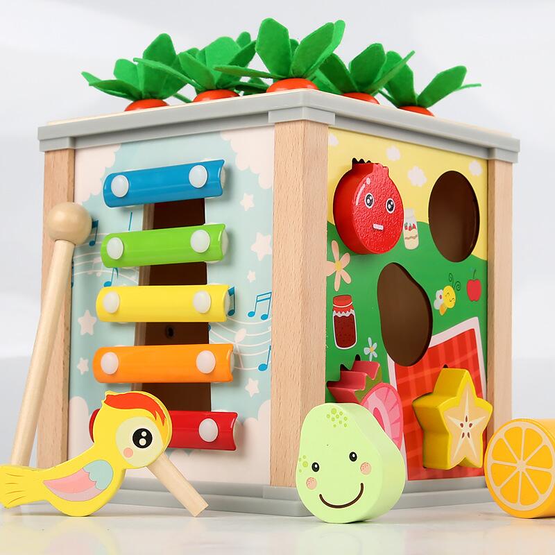 A toy box neatly organized with a majority of wooden toys and a few select plastic items.