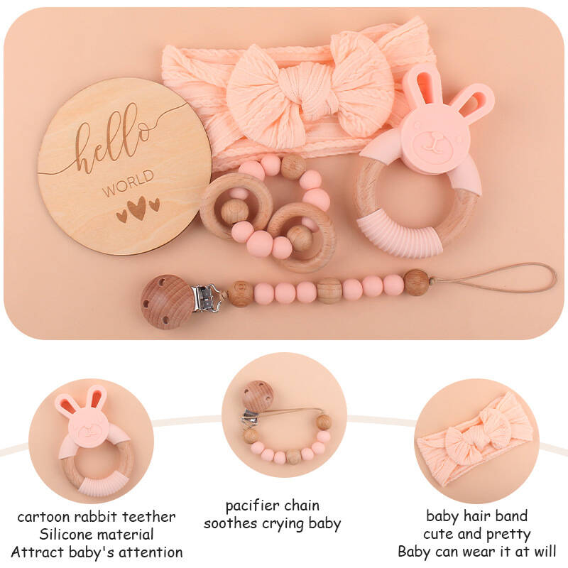 A baby safely chewing on a smooth, unpainted beechwood teething ring