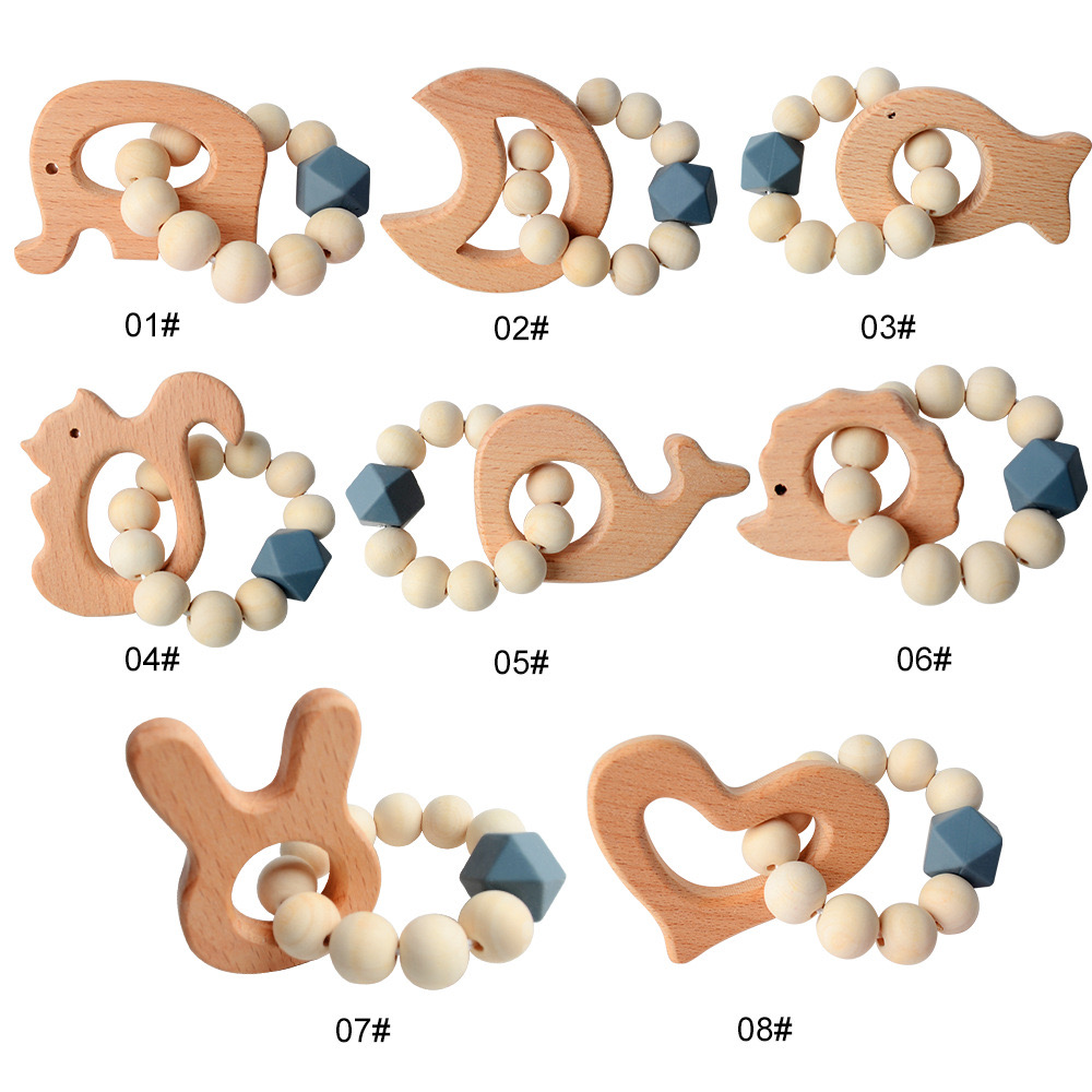An infant's hand easily gripping a lightweight wooden dumbbell rattle